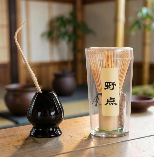 LISATA MATCHA mini bamboo whisk, scoop, and black ceramic stand set for matcha tea preparation on a wooden table
