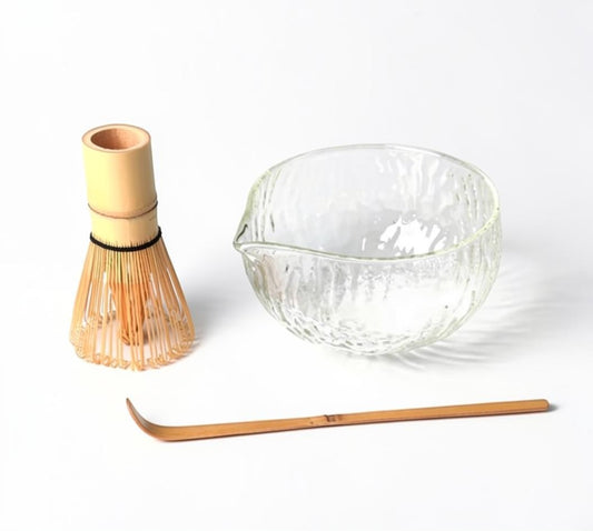 LISATA MATCHA set featuring a clear textured glass latte bowl, a bamboo chasen whisk, and a bamboo tea scoop.