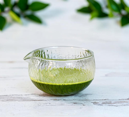 LISATA MATCHA 16oz glass matcha latte bowl with textured finish and pouring spout on a white wooden surface