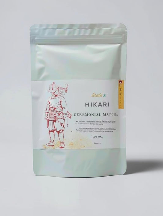 LISATA MATCHA Hikari ceremonial matcha in a sealed pale green pouch with traditional Japanese warrior illustration.
