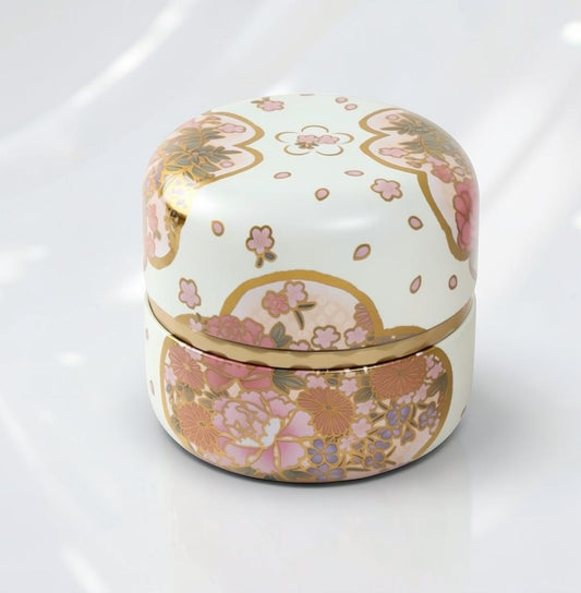 LISATA MATCHA Japanese aluminum tea canister with a white floral pattern and gold accents for fresh matcha storage.