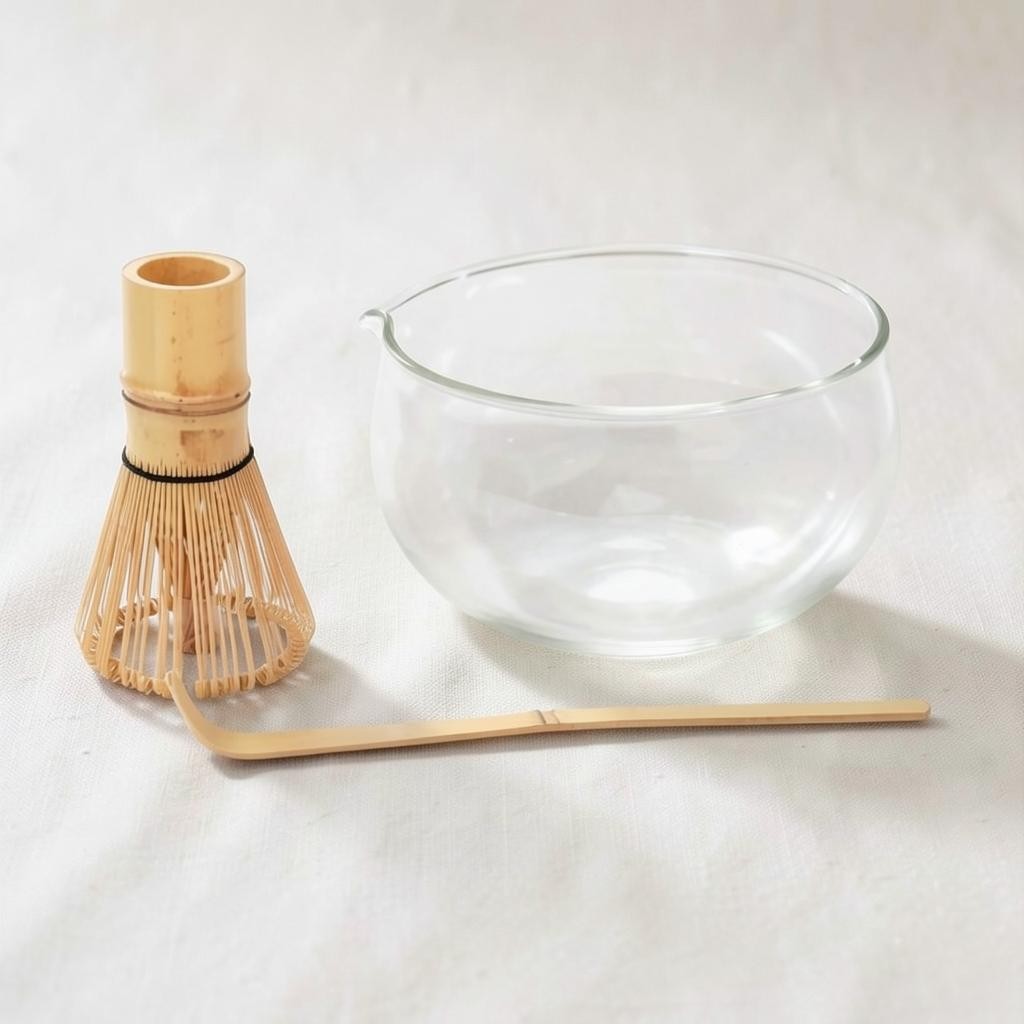 LISATA MATCHA starter bundle featuring a clear glass matcha bowl, bamboo whisk, and bamboo scoop on a neutral surface.